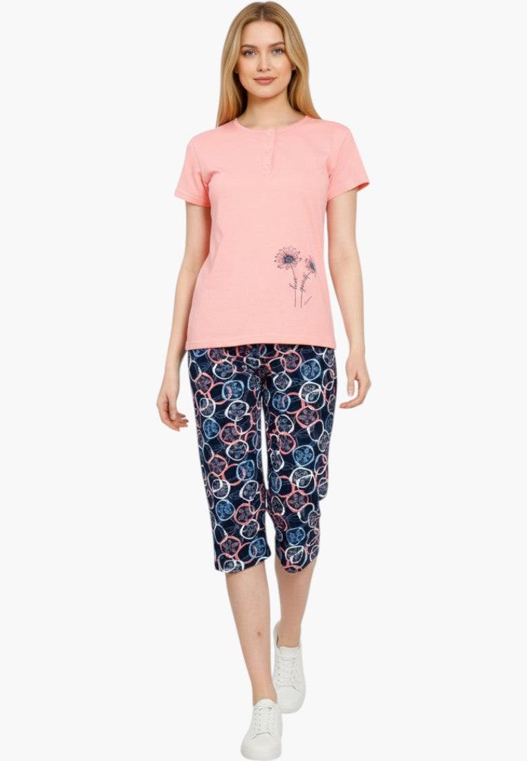Falio women's coral pink cotton pajama set with short sleeves, button neckline, and navy capri pants with a circular floral pattern.