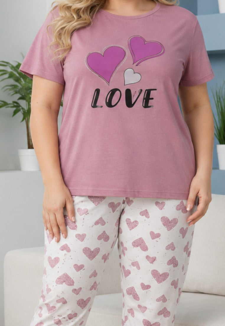 Falio women's cotton pajama set with a pink short-sleeve top featuring heart graphics and matching heart-print pants.