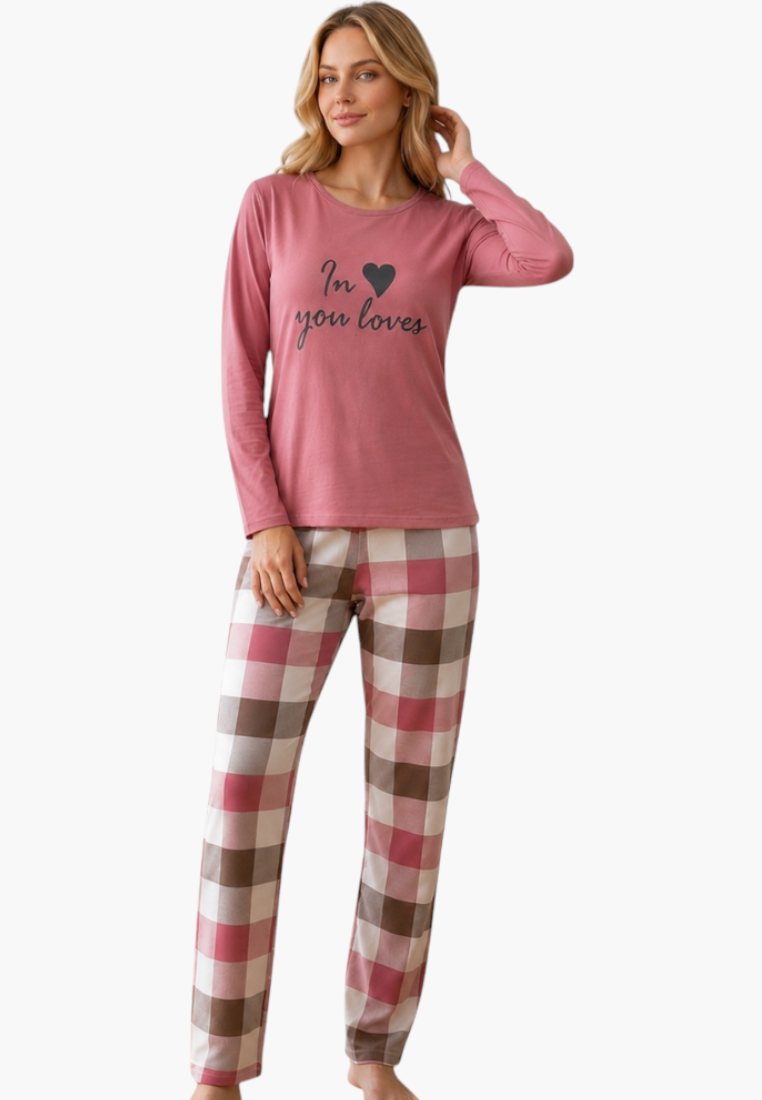 Model wearing a Falio long-sleeve pink cotton pajama top with heart graphic and plaid bottoms for cozy sleepwear.