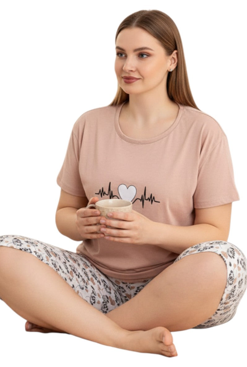 Falio women's 100% cotton pajama set with a pink t-shirt featuring a heartbeat and heart graphic, and patterned shorts.
