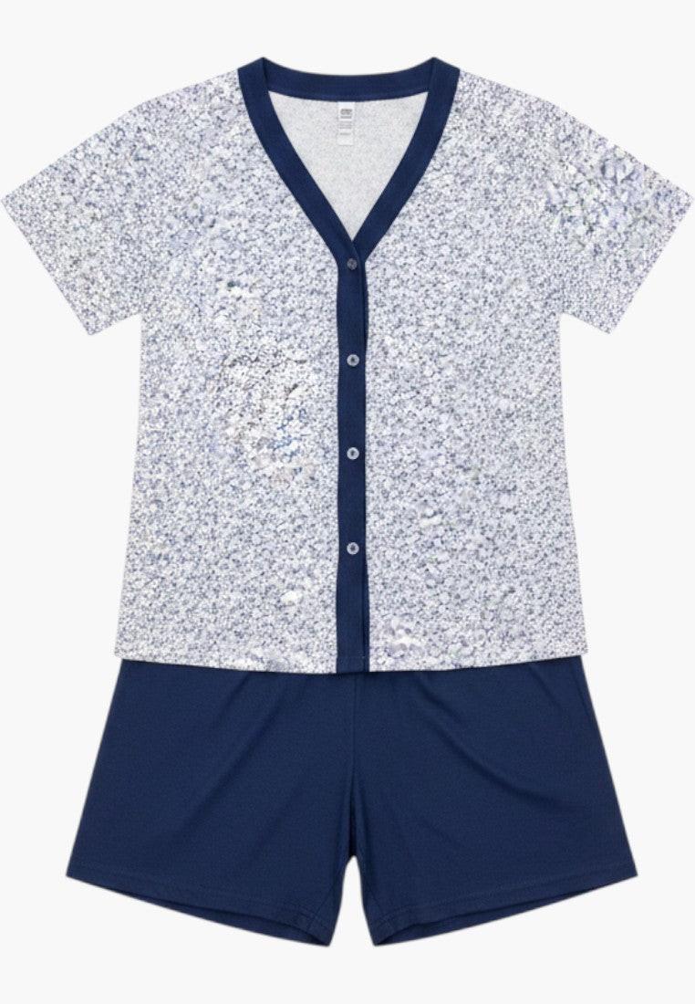 Falio women's plus size two-piece cotton pajama set with short sleeves, v-neck, and button-down top in a floral print, paired with navy blue 3/4 length shorts.