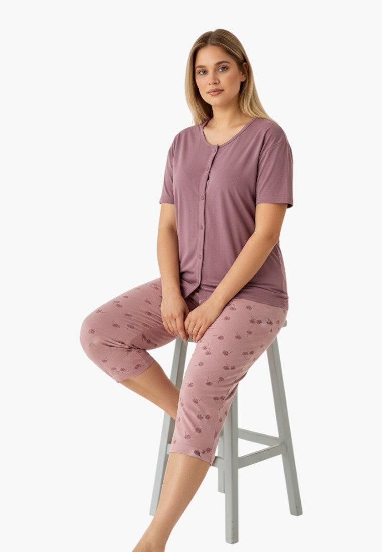 Falio women's plus size two-piece pajama set in mauve with a floral print on the capri pants. Features a short-sleeve button-up top and 3/4 length pants.