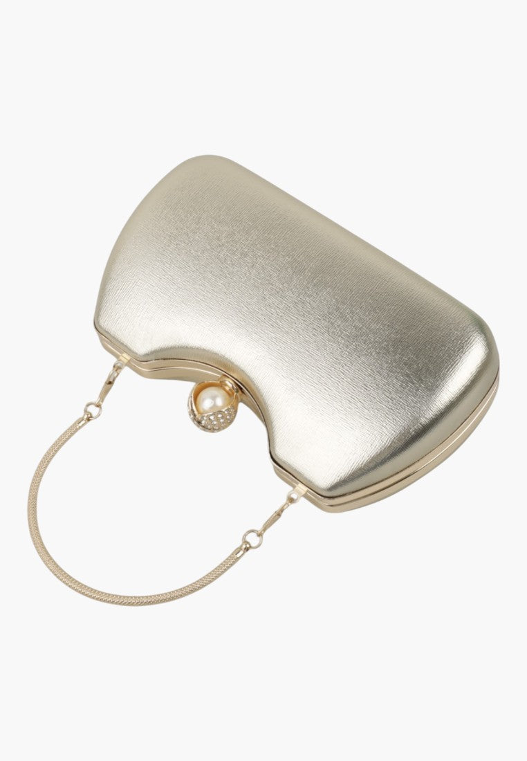 Side view of a silver handbag featuring a gold clasp and rounded shape on a white background.