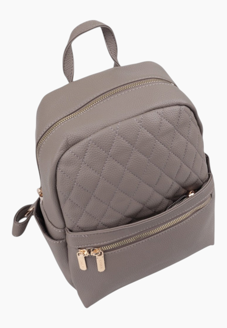 Detail close-up of the quilted gray backpack showing the double zipper.