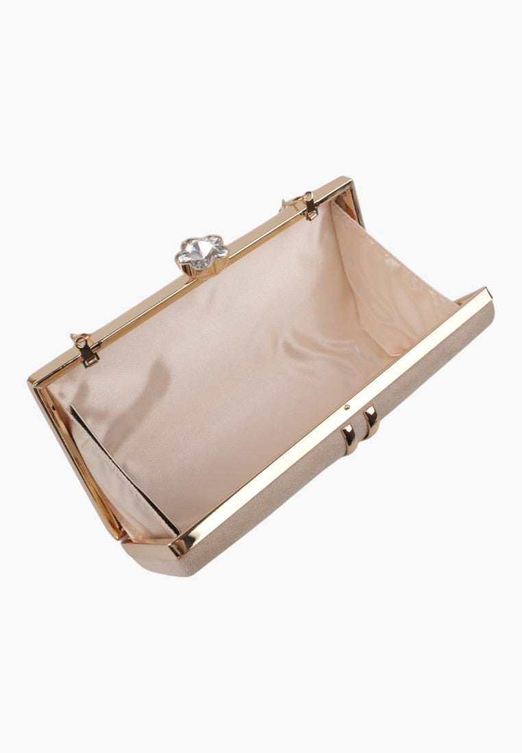 Detail shot of the interior of a handbag with smooth lining and metal frame on a white background