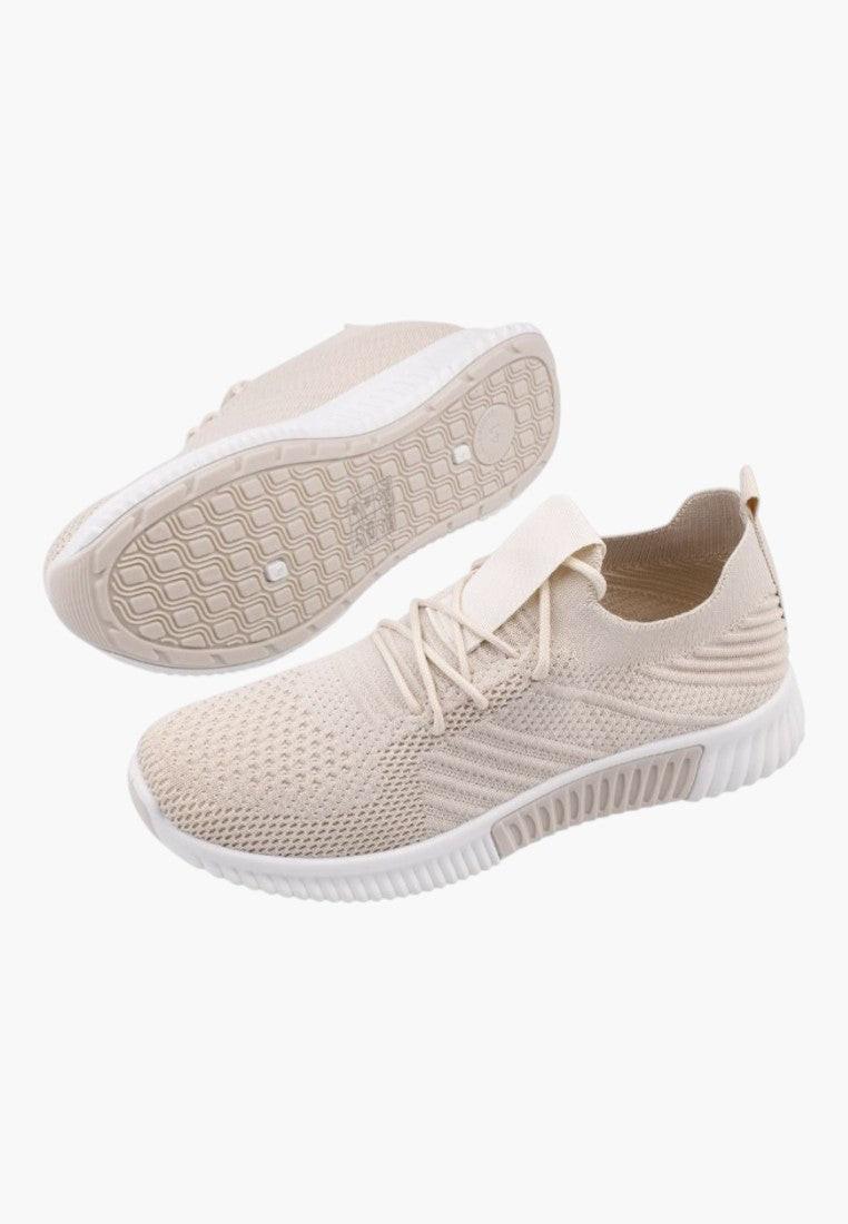 Ogólny widok jasno beżowych sneakersów damskich z elastycznym zapięciem.