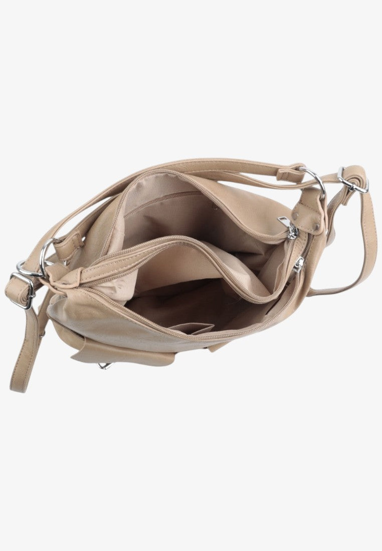 Detail close-up of the interior of the beige handbag showing multiple compartments and shoulder strap on a white background.
