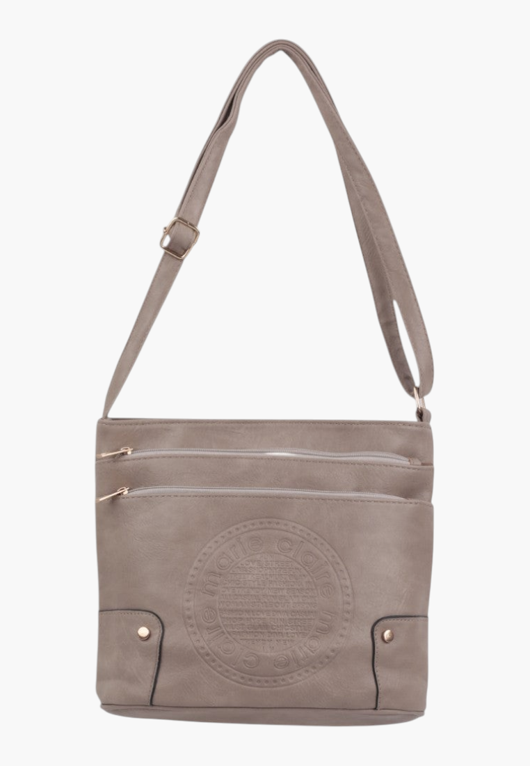 Detail close-up of textured surface and stitching on khaki crossbody bag.