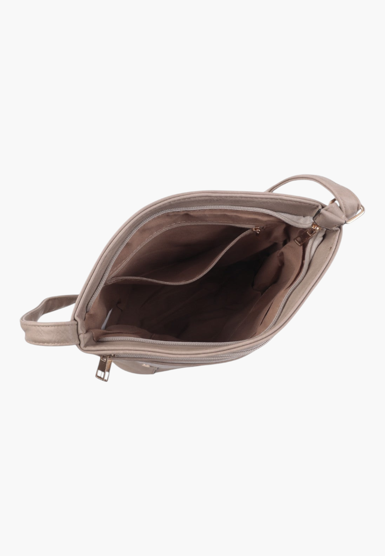 Interior view of khaki crossbody bag showing spacious compartment and lining.