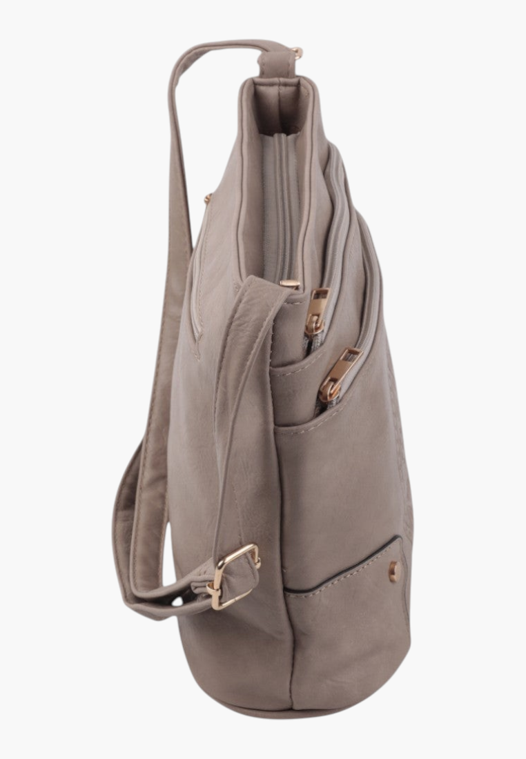 Side view of khaki faux leather crossbody bag with side pocket and adjustable strap.