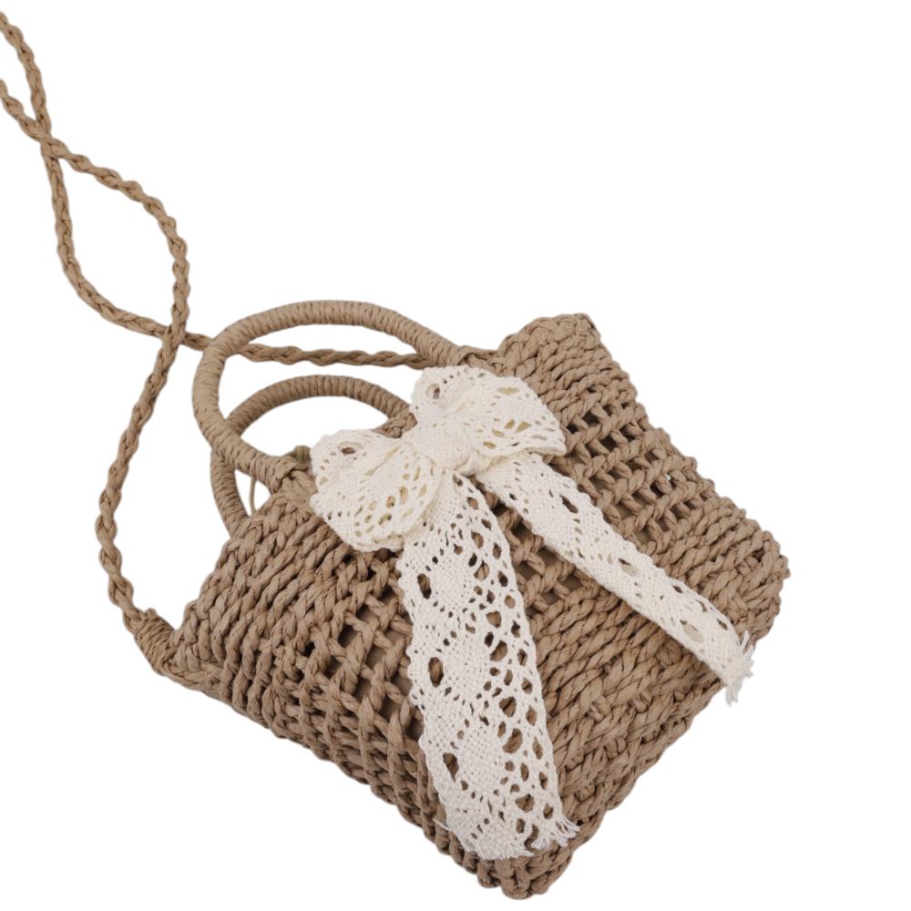 Close-up of a brown and white woven handbag highlighting the woven texture and bow detail.