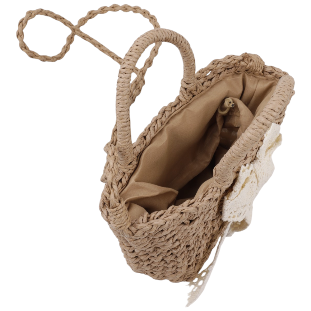 Detail shot of the interior lining of a brown and white woven handbag with a bow detail.