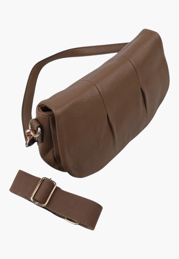 Side view of the brown handbag showcasing a detachable strap and zipper closure on a white background.