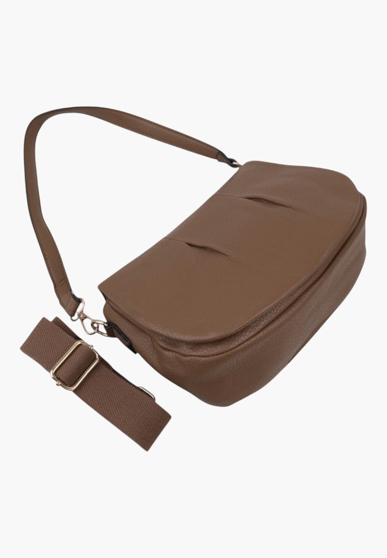 Side view of the brown handbag with detachable strap and zipper closure displayed on a white background.