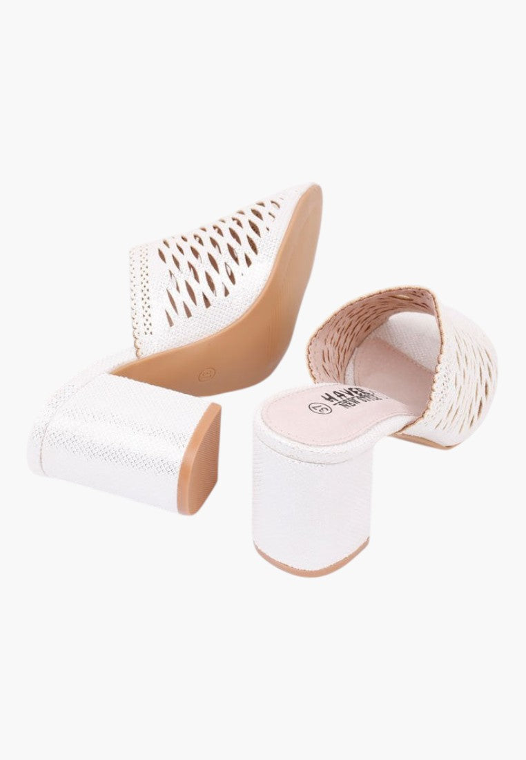 Other angle of white heeled sandals showcasing open toe and chunky heel on a white background