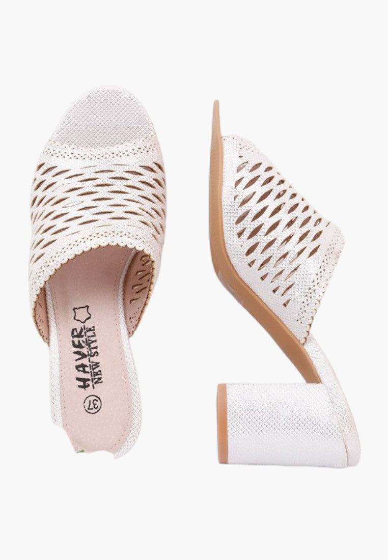 Side view of white heeled sandals with woven design and open toe on a white background