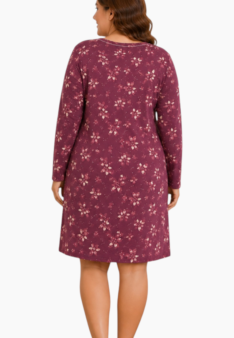 Close-up detail of a floral nightgown in purple and white with long sleeves and V-neck.