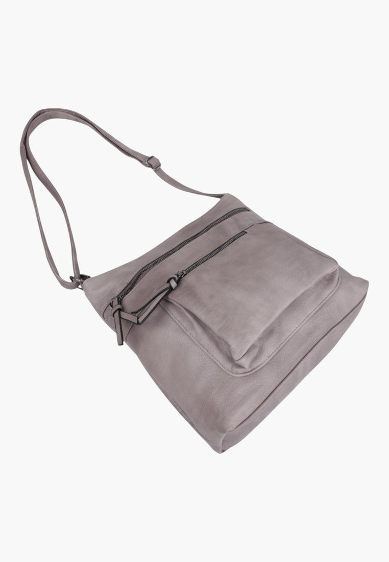 Side view of a light grey crossbody bag showcasing its faux leather material.