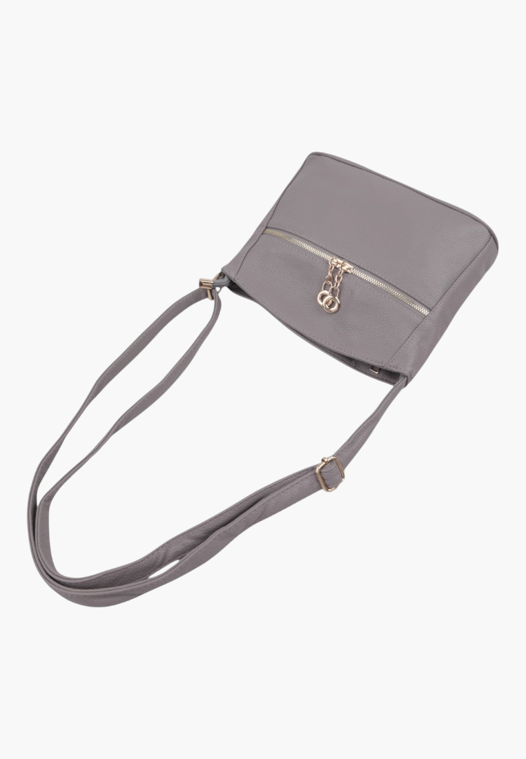 Front view of a gray handbag featuring a gold logo and adjustable strap.