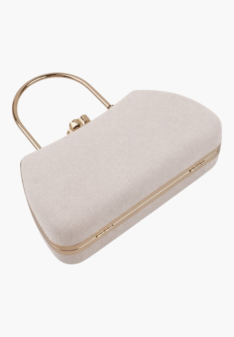 Close-up detail of a light pink handbag showcasing the top handle and gold clasp on a white background.