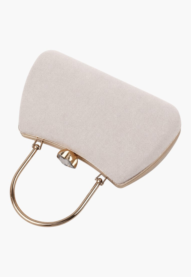 Close-up detail of a light pink handbag highlighting the top handle and gold clasp on a white background.