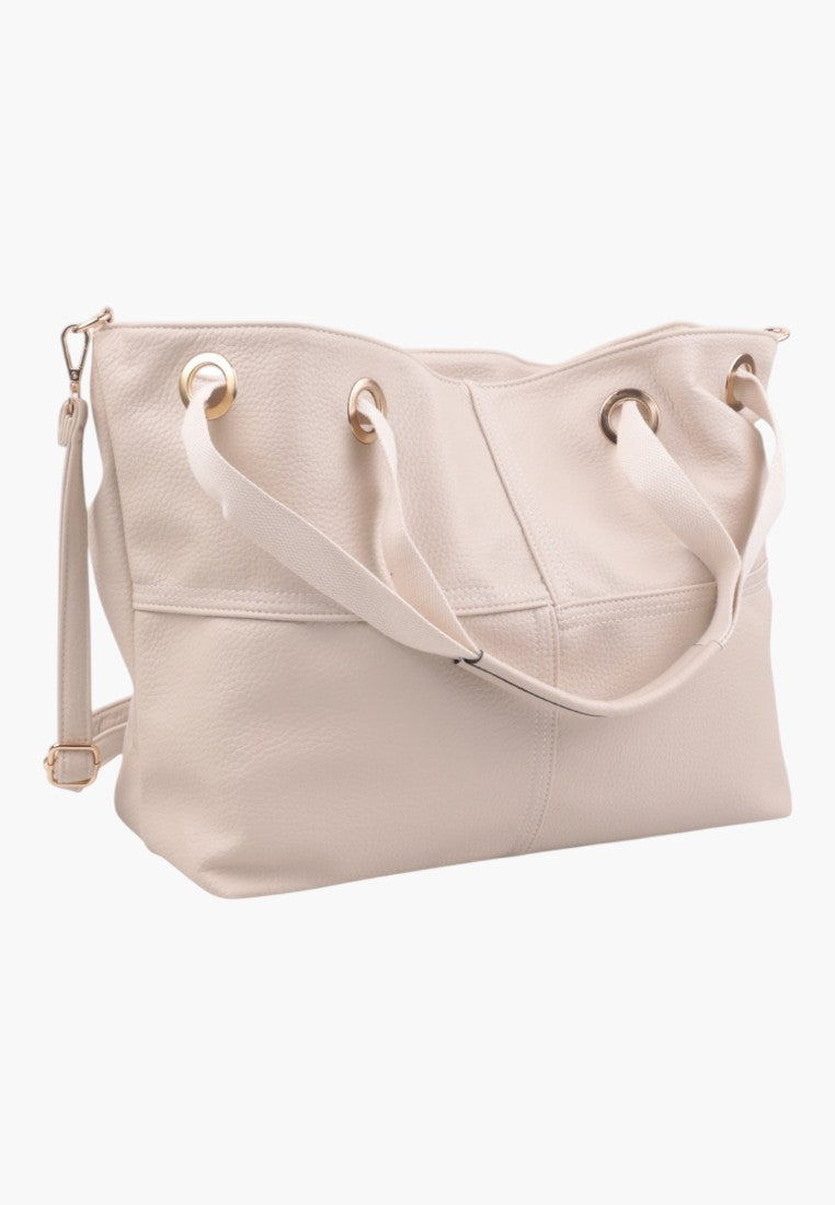 Side view of a light pink handbag made of soft material.