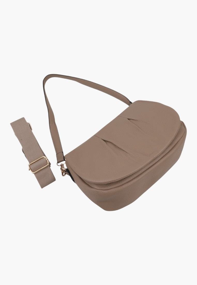 Side view of the brown handbag with adjustable strap and flap closure on a white background.