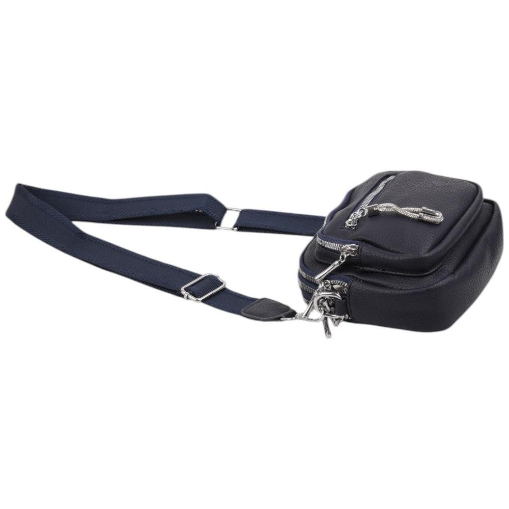 Side view of a navy crossbody bag with a zipper closure and compact design.