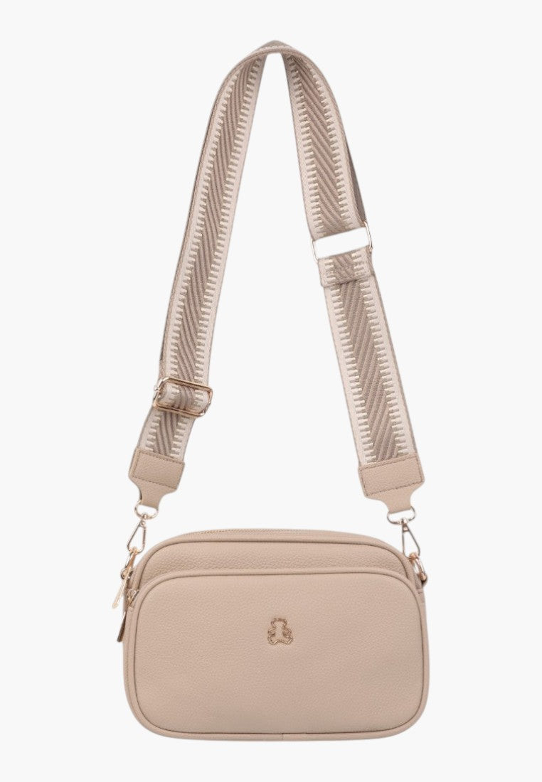 Back view of a khaki crossbody bag with minimalist design and zipper closure.