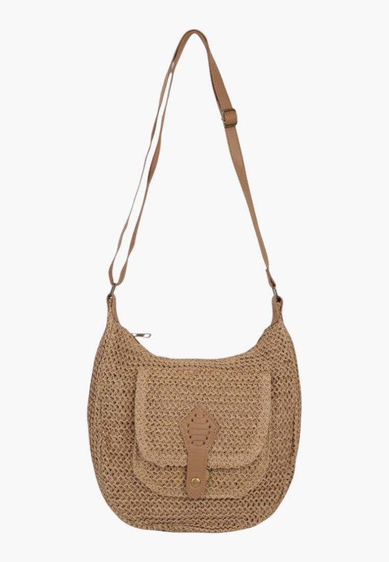 Side view of the woven handbag in brown featuring an adjustable strap and front flap.
