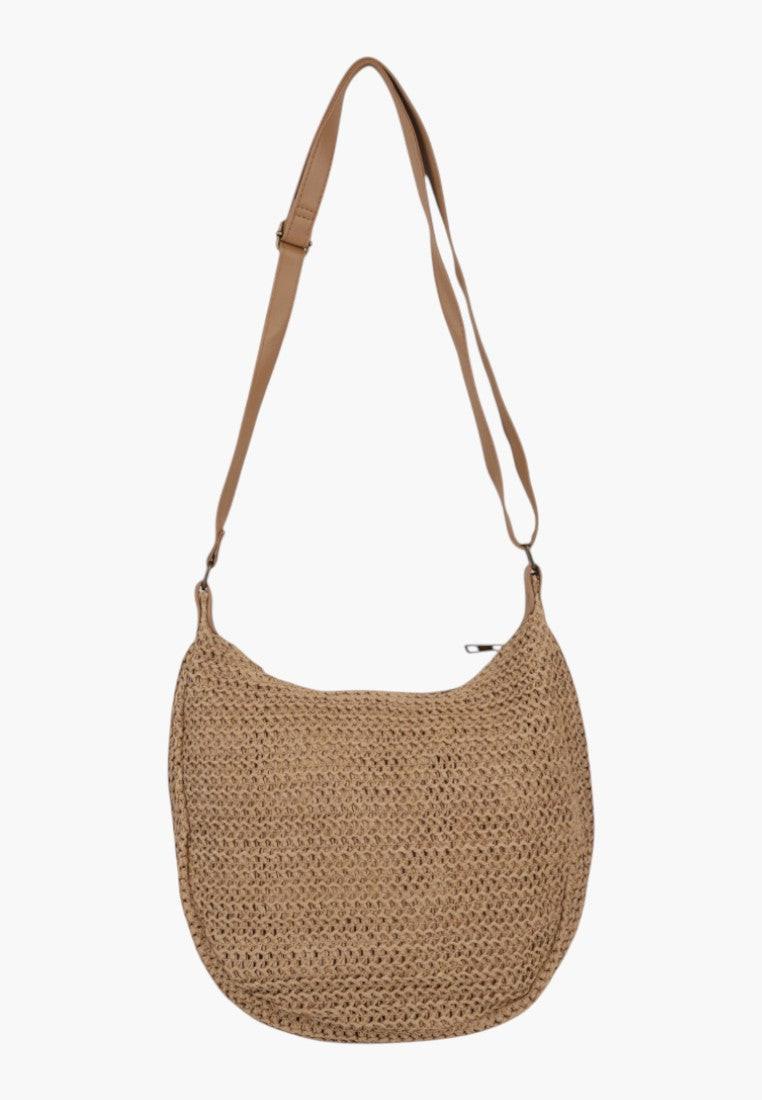Side view of a simple brown woven handbag with an adjustable strap.