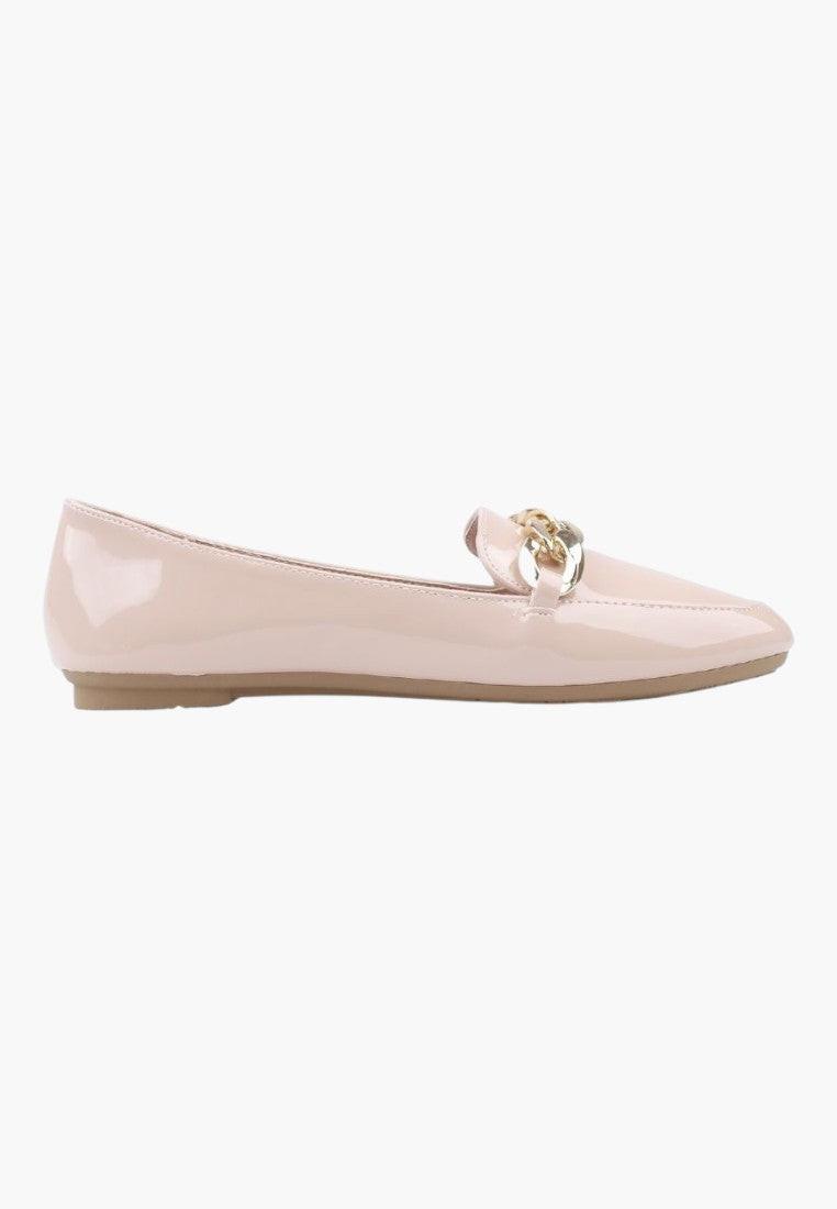 Side view of pink slip-on shoes featuring a flat sole and gold chain detail.