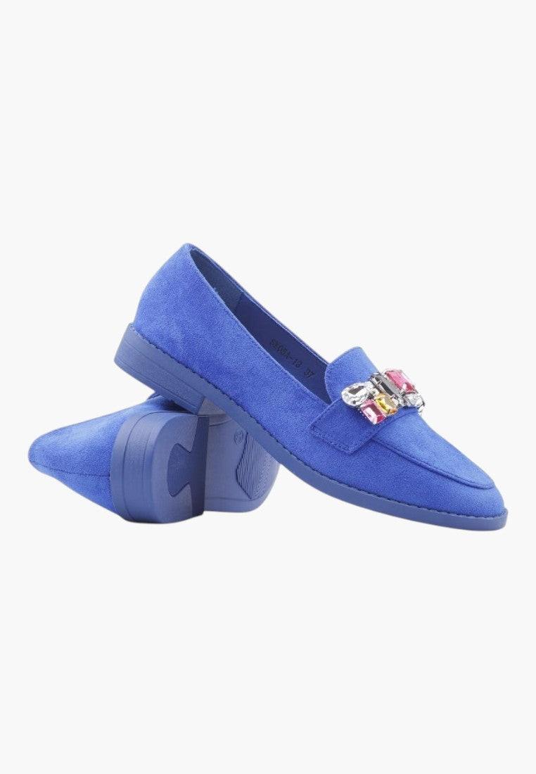 Back view of blue moccasin shoes featuring a flat heel and decorative strap.