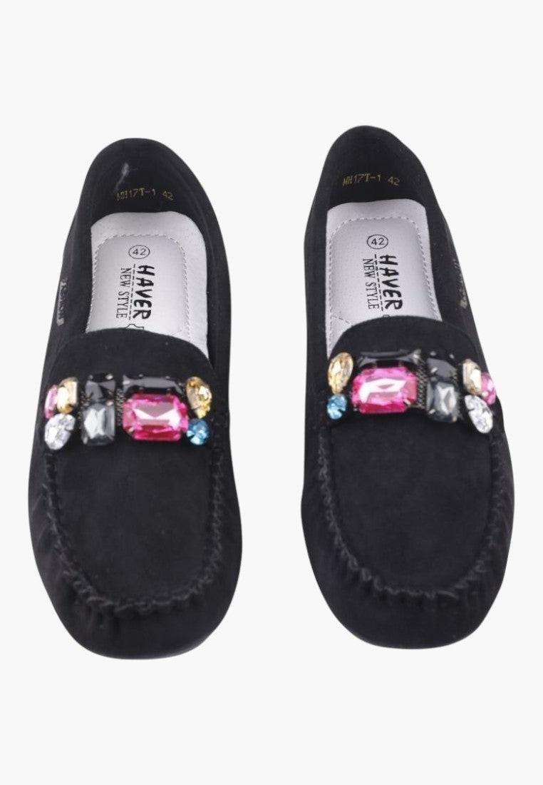 Back view of black women's moccasins with a textured sole.