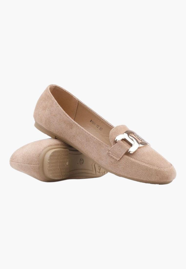 Side view of beige loafers with a decorative buckle and flat sole.