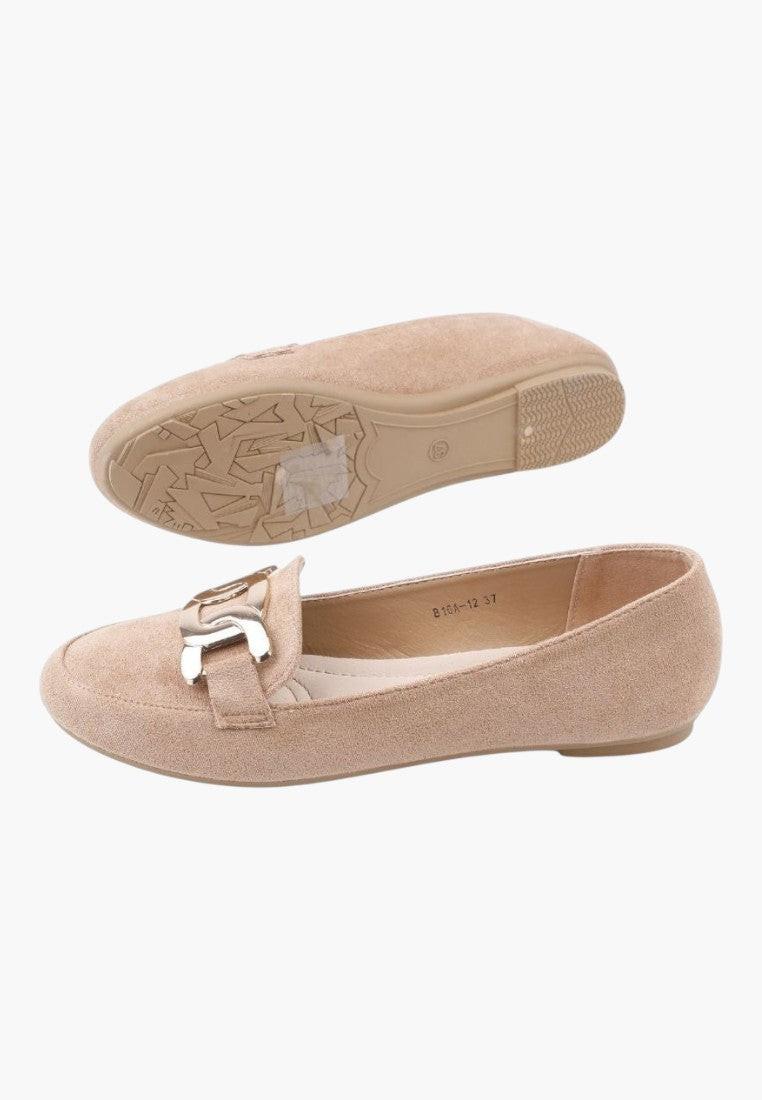 Side view of beige loafers featuring a decorative buckle and flat sole.