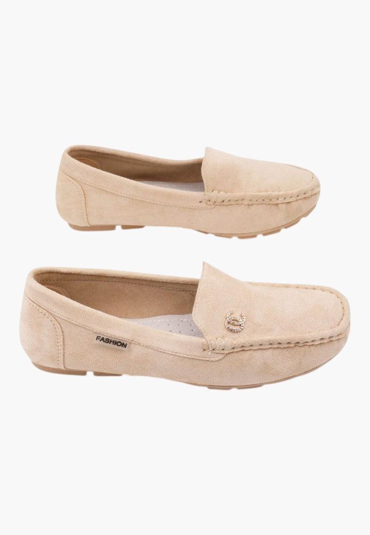 Front view of beige slip-on shoes made of soft material.