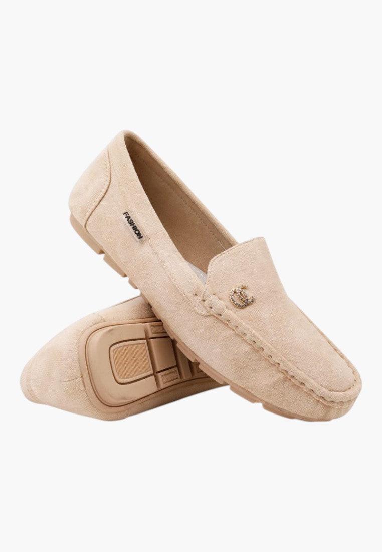 Side view of beige slip-on shoes showcasing casual style.