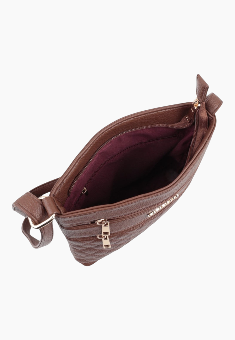 Detail view of the interior of the brown bag with a zippered closure and fabric lining.