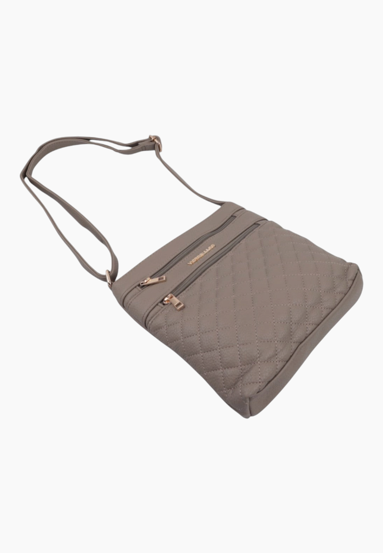 Side view of the brown crossbody bag with a quilted design and adjustable strap.