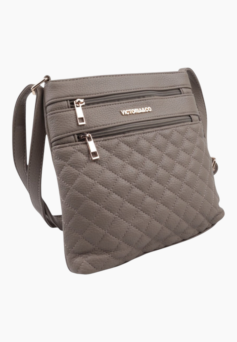 Detail view of the gray quilted shoulder bag with zipper pockets.
