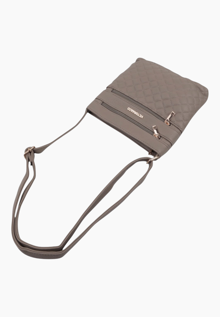 Side view of the gray shoulder bag showcasing an open design with two zipper pockets.