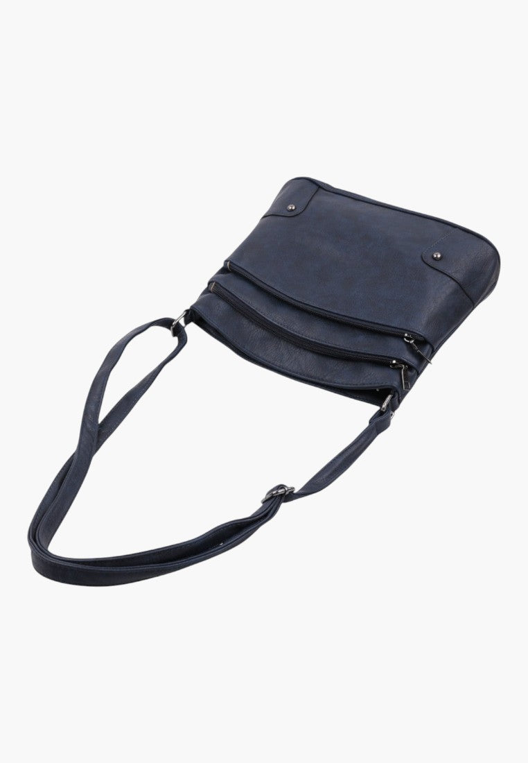 Zbliżenie na granatową torebkę crossbody z wieloma zamkami błyskawicznymi i regulowanym paskiem.