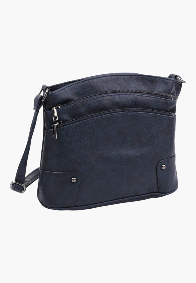 Przedni widok granatowej torebki crossbody z sztucznej skóry z zamkami błyskawicznymi i srebrnymi akcentami.
