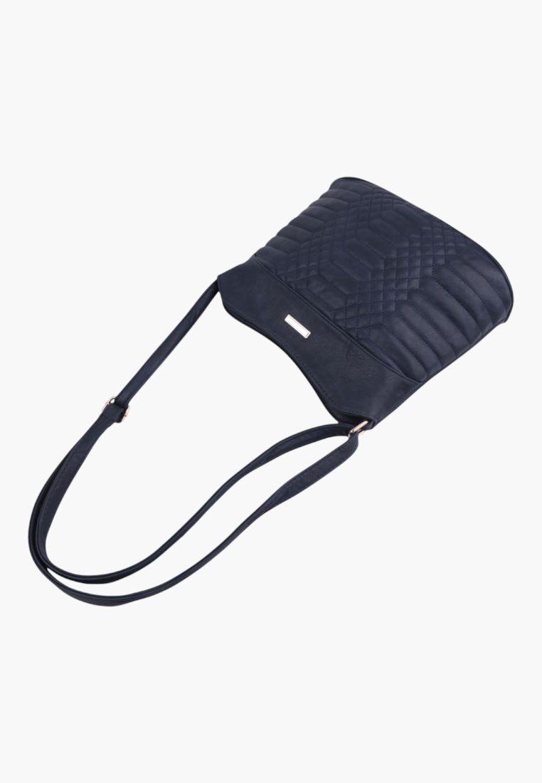 Side view of navy quilted faux leather crossbody bag with long adjustable strap and zip closure.