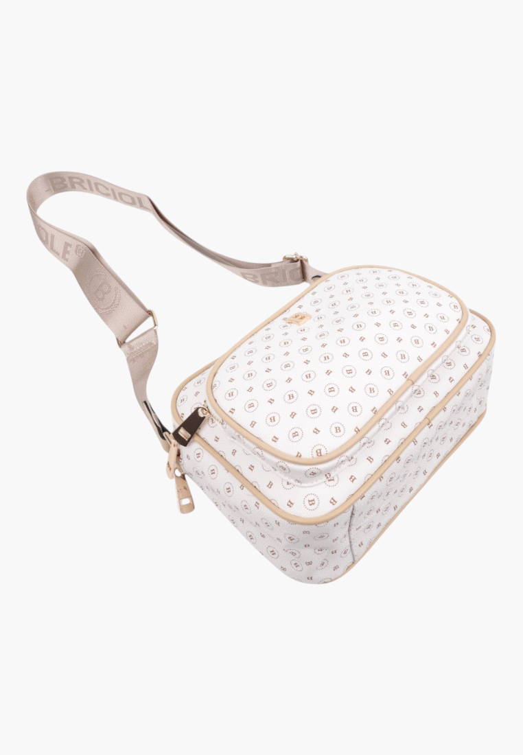 Detail shot of the off-white crossbody bag showing the zipper closure and padded design.