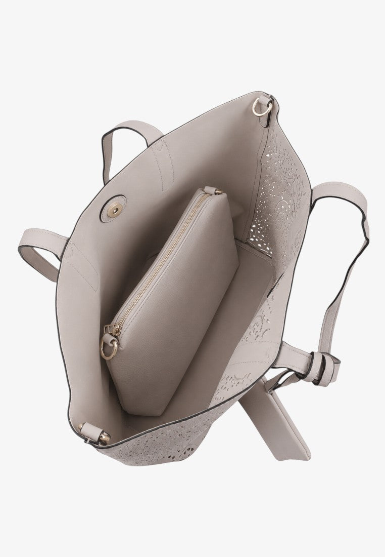Detail shot of the beige handbag interior with two compartments and a snap closure.