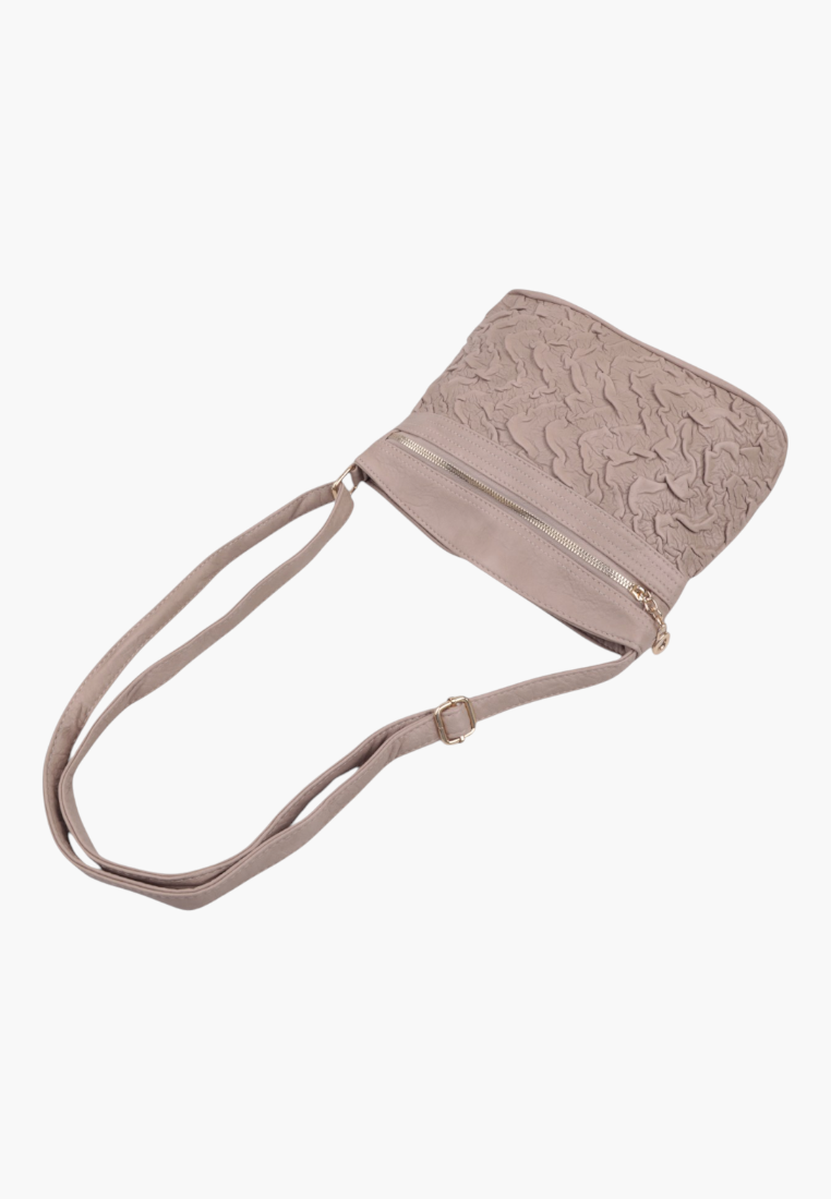 Other angle of a beige crossbody bag with an adjustable strap and flap closure.