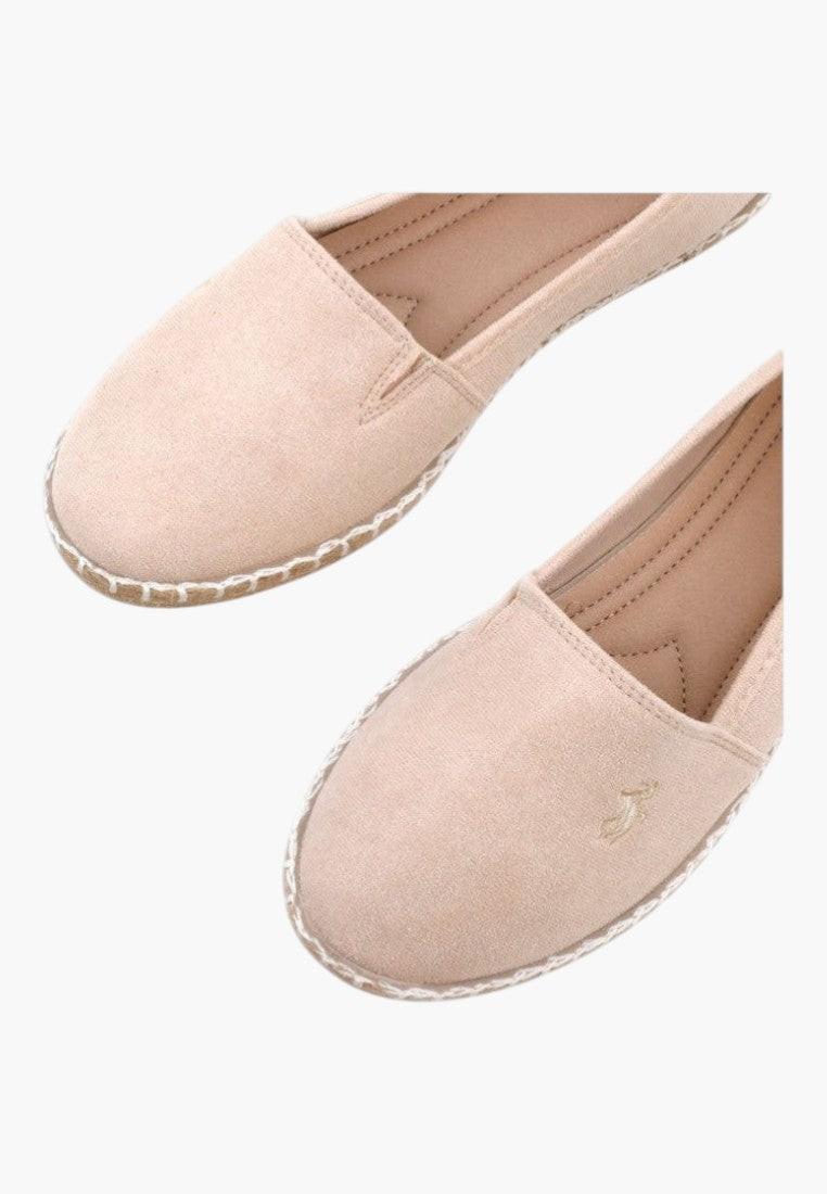 Detail view of pink slip-on shoes with smooth fabric and rounded toe