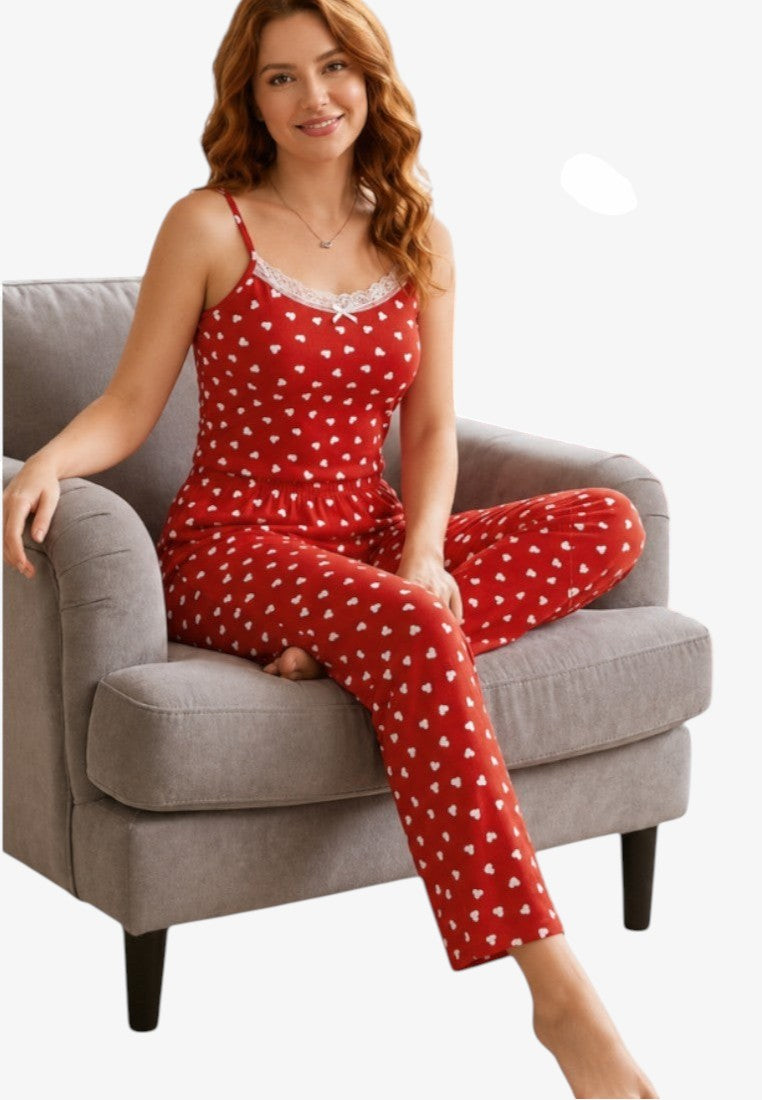 Lifestyle shot of red pajamas with heart print, featuring spaghetti straps and lace trim.